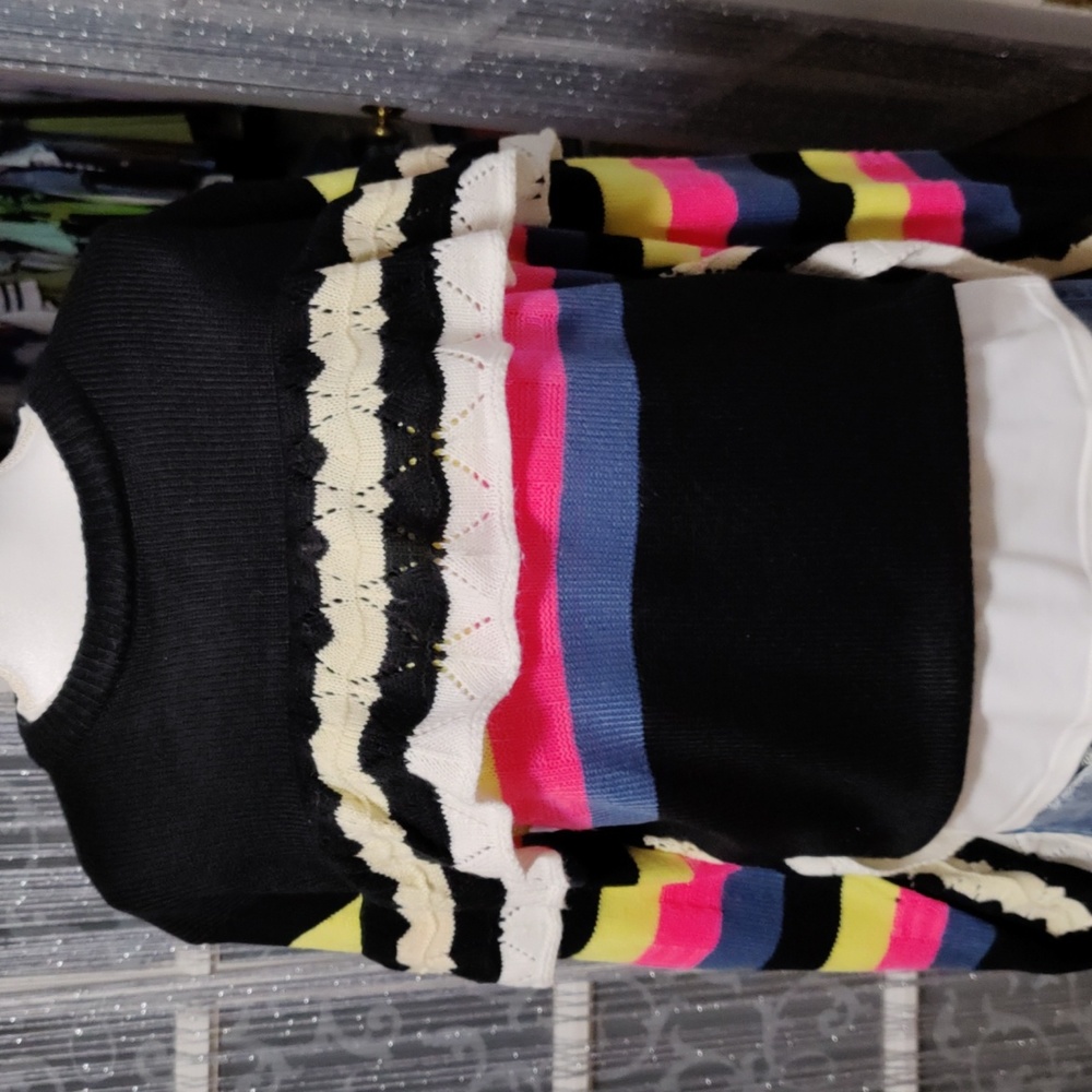 This sweater is a size medium and true to size. Black and multi colors